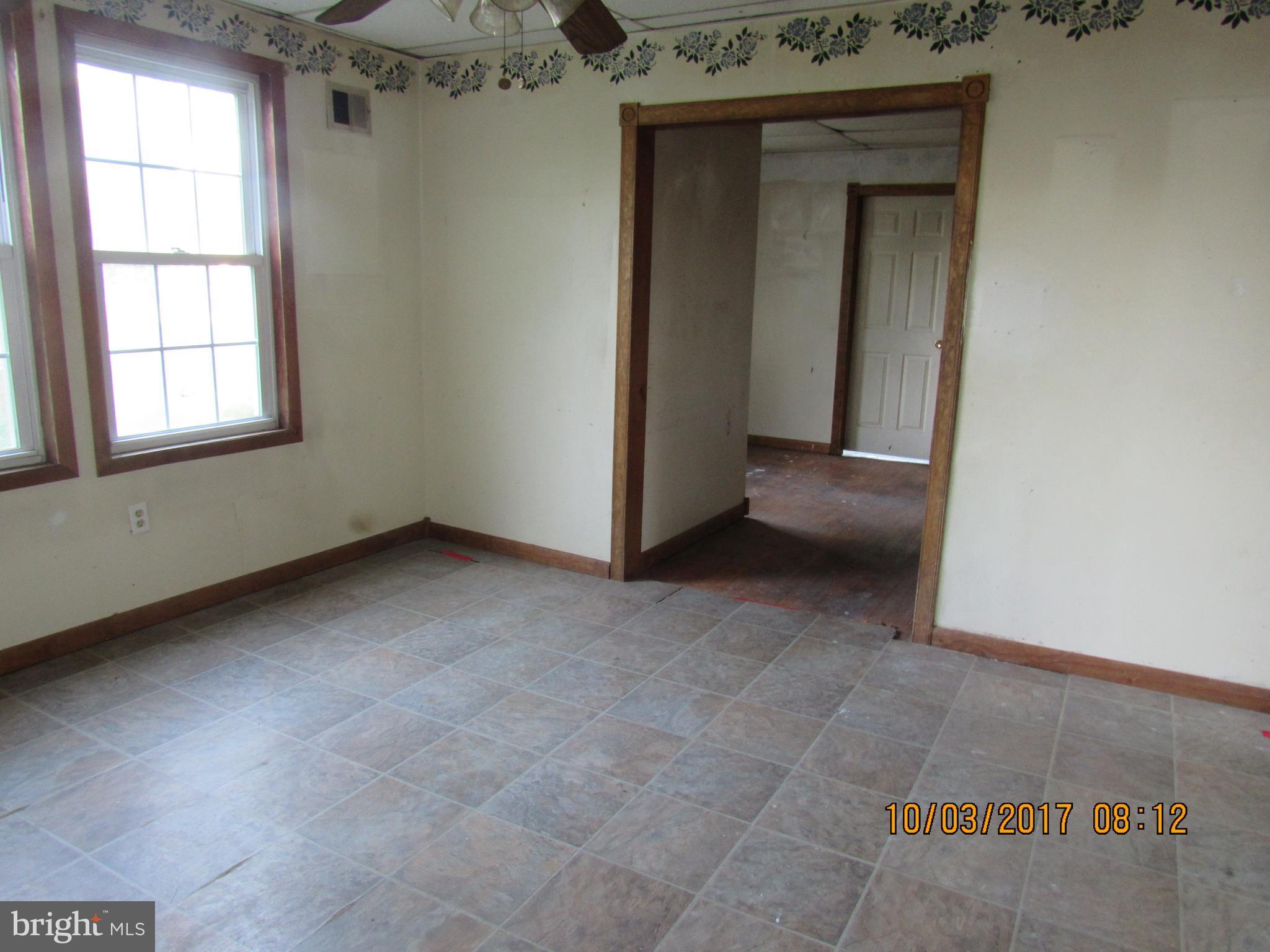 2907 Sparrows Point Road Baltimore, MD 21219 - Photo 10 of 24 an empty room with a fireplace