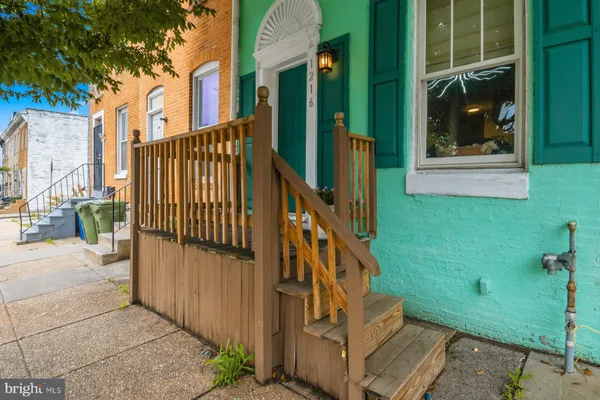 a view of a house with a small yard and wooden floor and fence