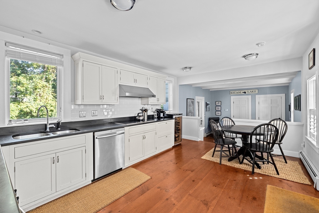 74 Tilden Road Scituate, MA 02066 - Photo 12 of 42 a kitchen with white cabinets sink dining table and chairs