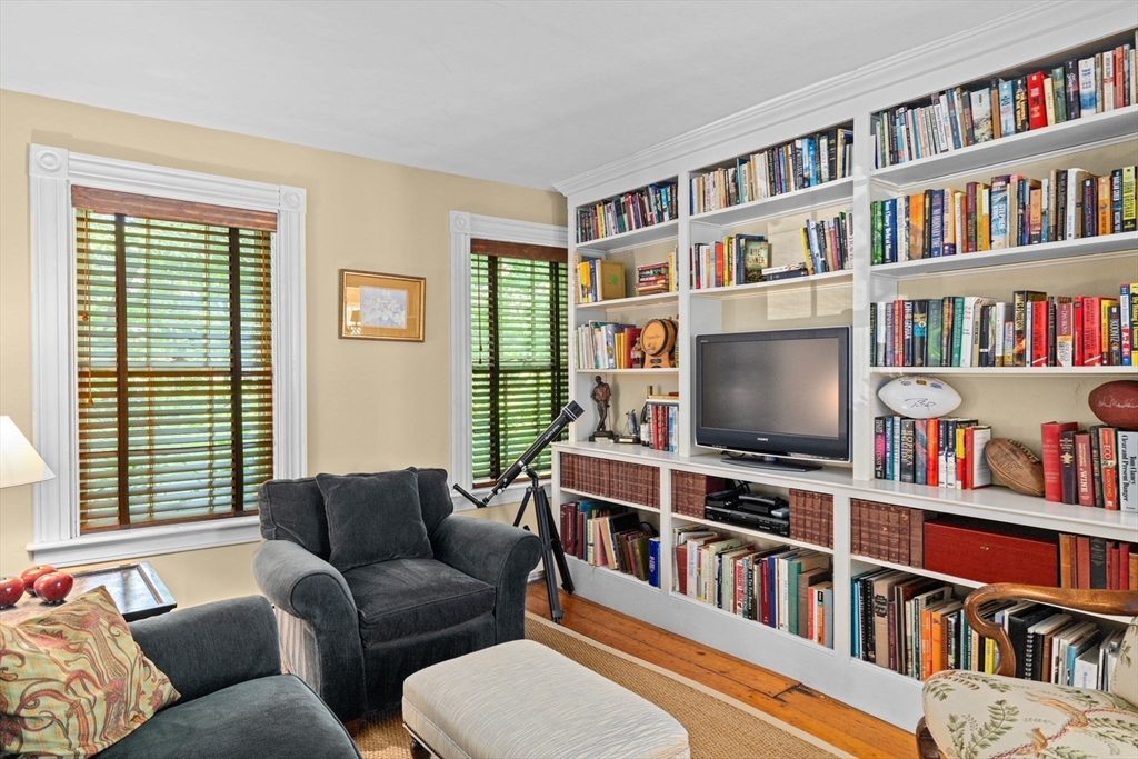 74 Tilden Road Scituate, MA 02066 - Photo 21 of 42 a living room with large lots of furniture and a book shelf