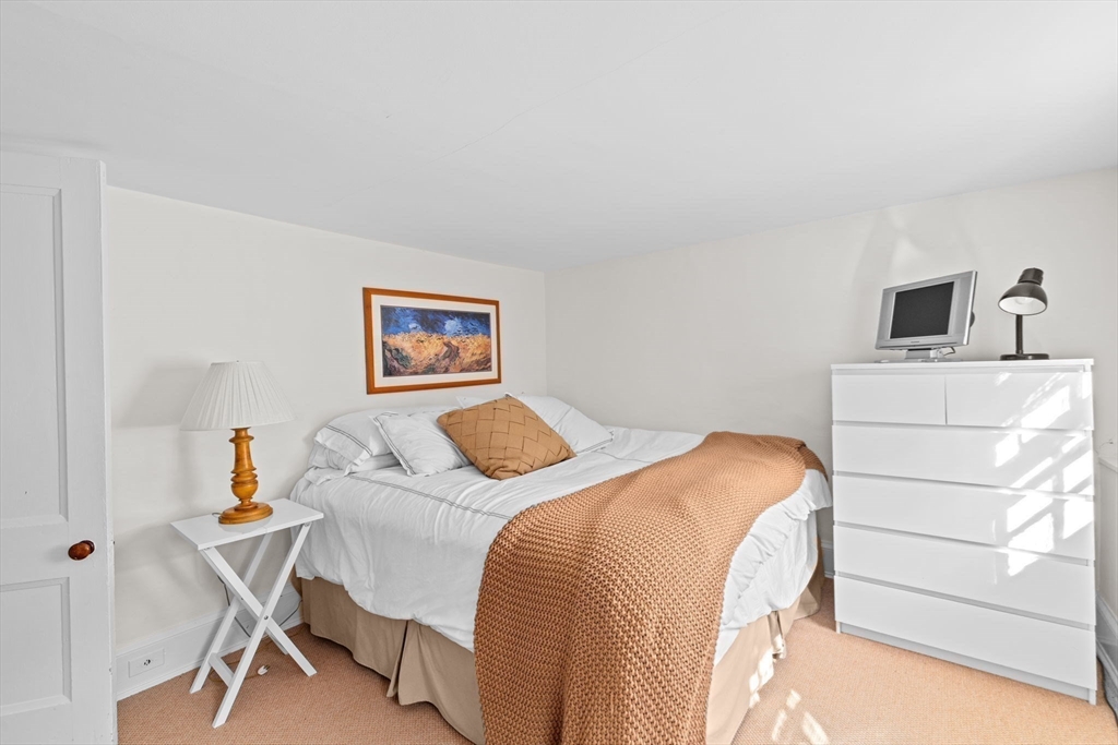 74 Tilden Road Scituate, MA 02066 - Photo 30 of 42 a bedroom with a bed and a dresser