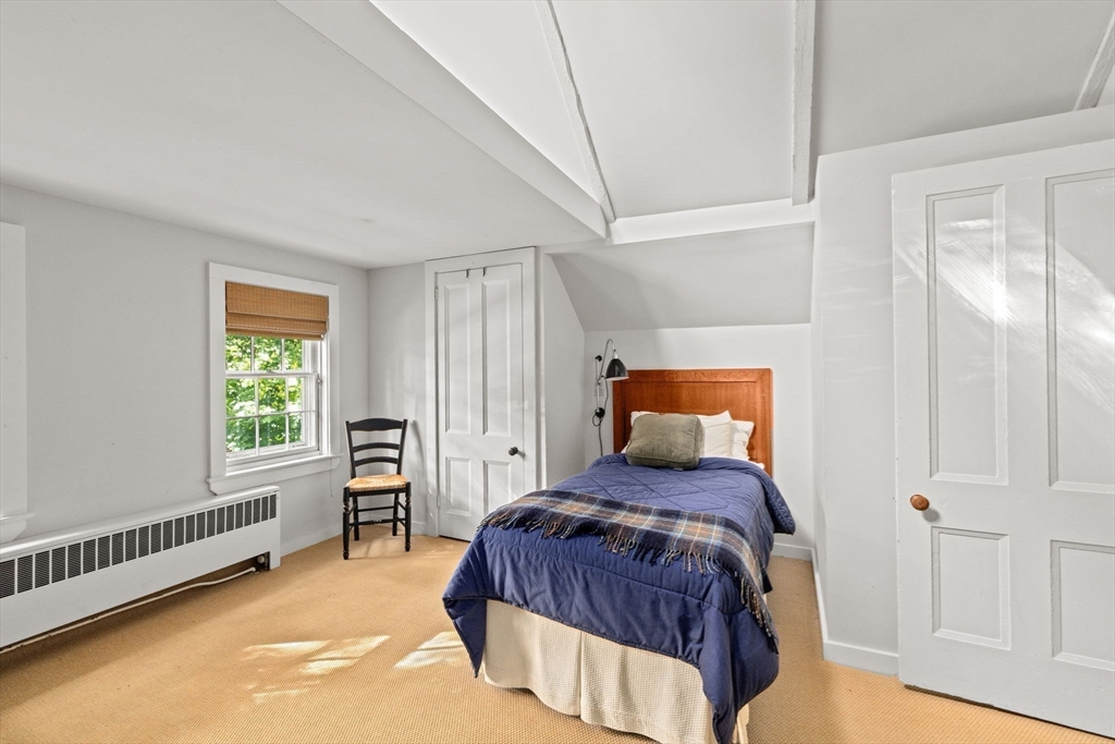 74 Tilden Road Scituate, MA 02066 - Photo 32 of 42 a bedroom with a bed and a window