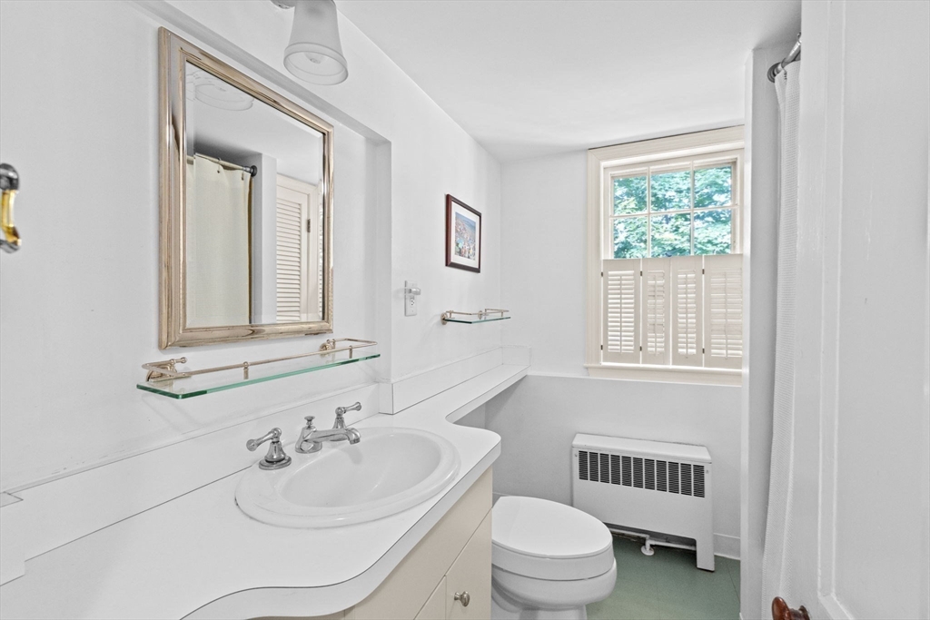 74 Tilden Road Scituate, MA 02066 - Photo 33 of 42 a bathroom with a toilet a sink and mirror