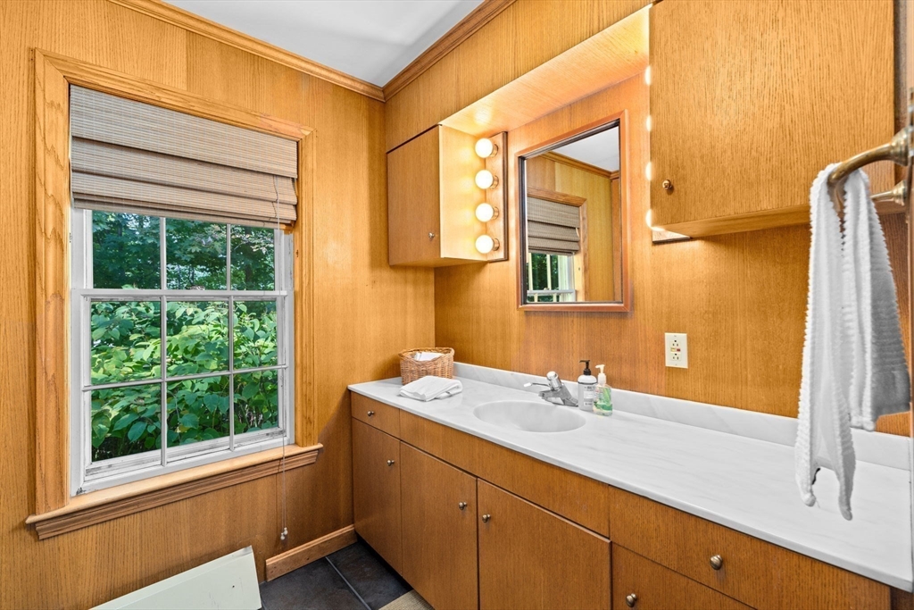 74 Tilden Road Scituate, MA 02066 - Photo 34 of 42 a bathroom with a sink and a mirror