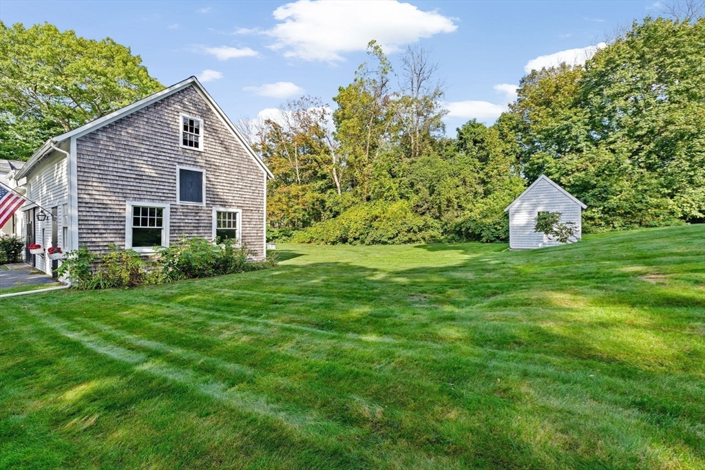 74 Tilden Road Scituate, MA 02066 - Photo 38 of 42 a front view of a house with a yard and garage