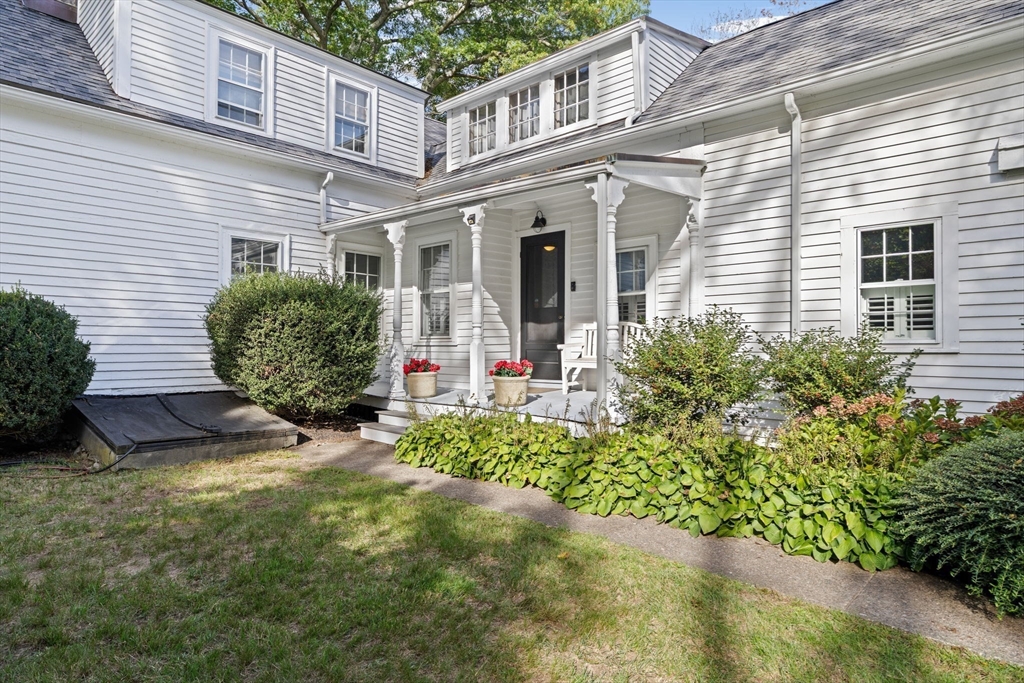 74 Tilden Road Scituate, MA 02066 - Photo 5 of 42 a view of a house with potted plants and a table and chairs
