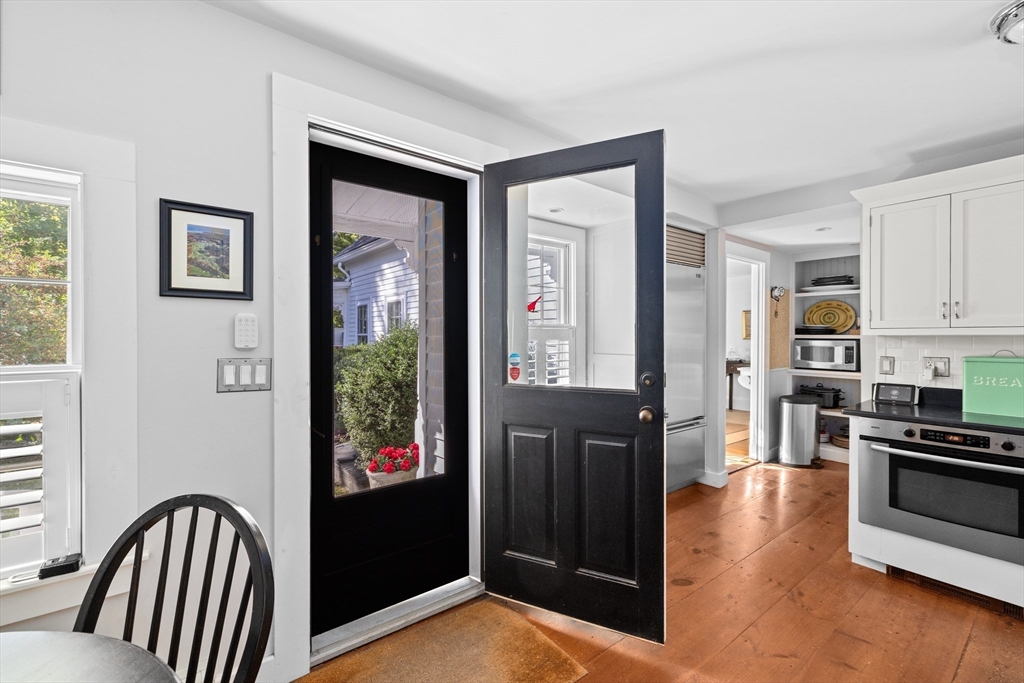74 Tilden Road Scituate, MA 02066 - Photo 7 of 42 a view of a kitchen with stainless steel appliances wooden floor and a window