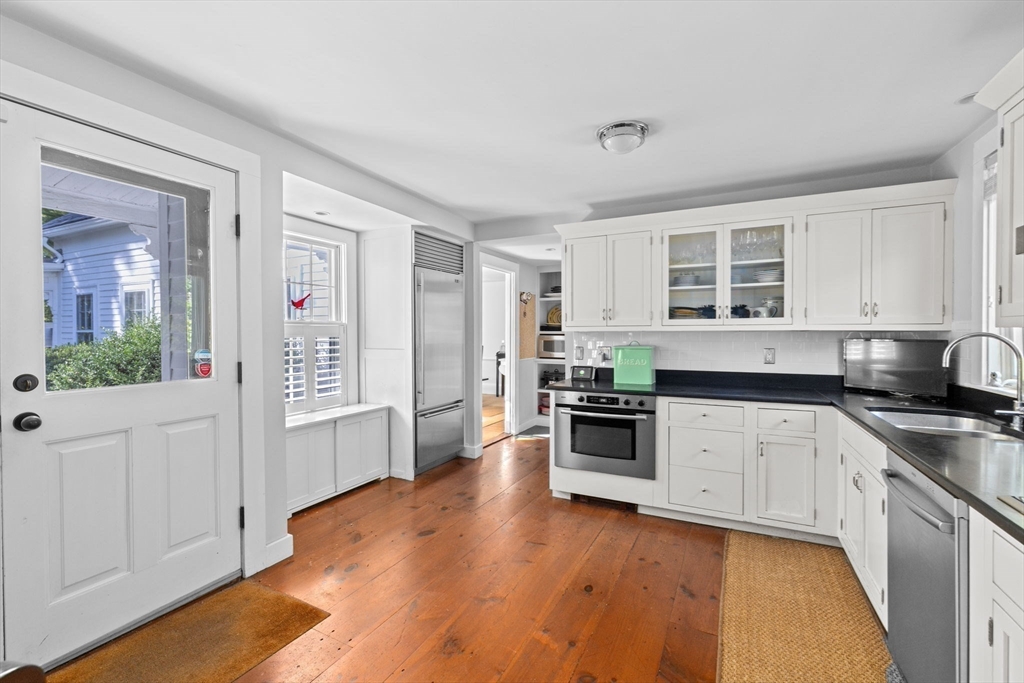 74 Tilden Road Scituate, MA 02066 - Photo 8 of 42 a kitchen with stainless steel appliances granite countertop a stove and cabinets