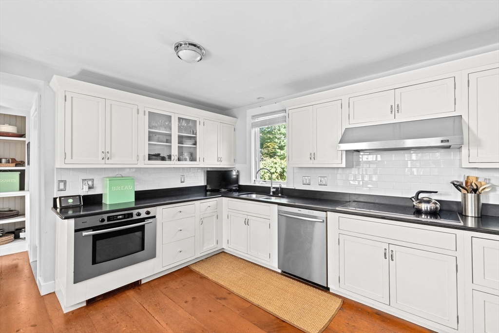 74 Tilden Road Scituate, MA 02066 - Photo 10 of 42 a kitchen with granite countertop white cabinets and white appliances