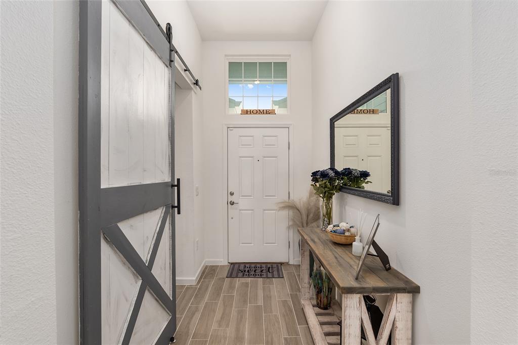 5688 Southwest 92nd Place Ocala, FL 34476 - Photo 7 of 54 a view of a hallway with wooden floor and staircase