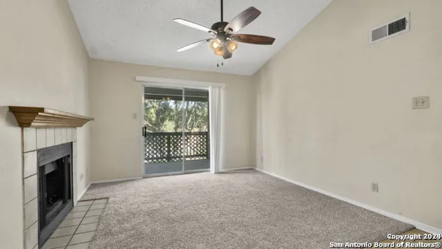 a view of an empty room with a fireplace