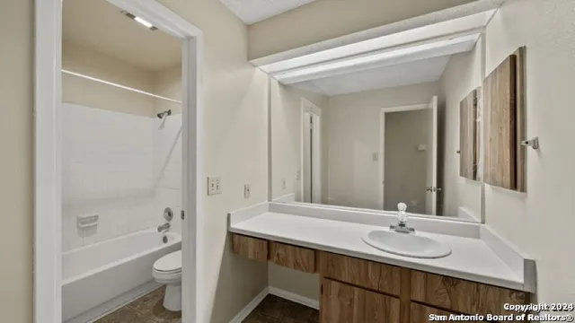 an empty room with ceiling fan and window