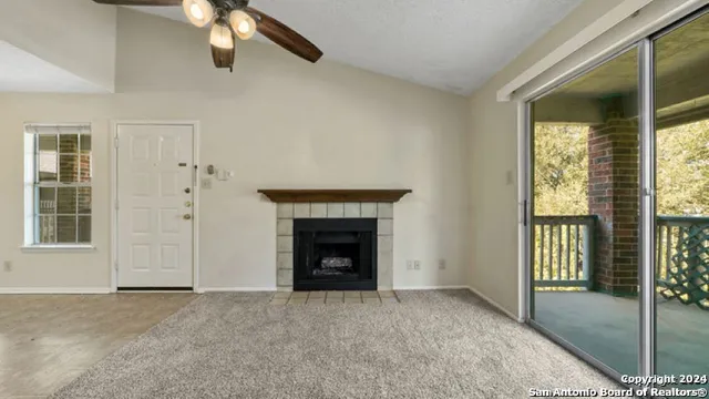 a view of empty room with windows and fireplace