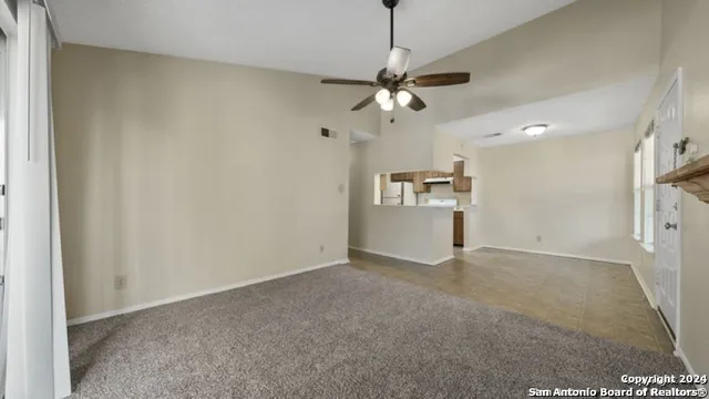 a view of a kitchen with a sink and a refrigerator