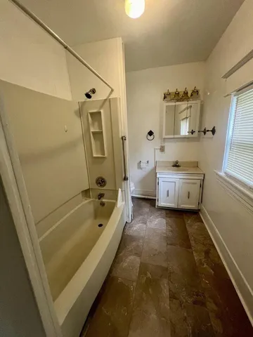 a bathroom with a tub toilet sink and shower
