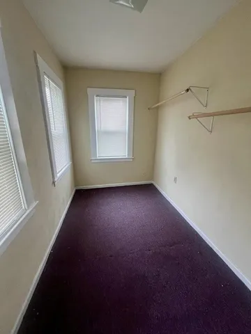 a view of room with hardwood floor and window