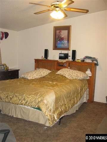 2159 Barberry Way Reno, NV 89512 - Photo 4 of 7 a bed sitting in a bedroom and painting on the wall