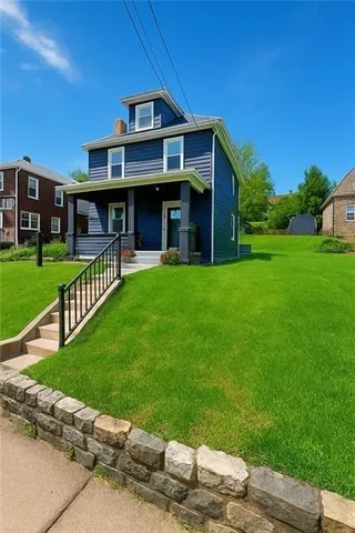 a front view of a house with a garden