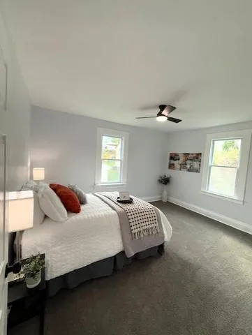 a bedroom with a bed and window