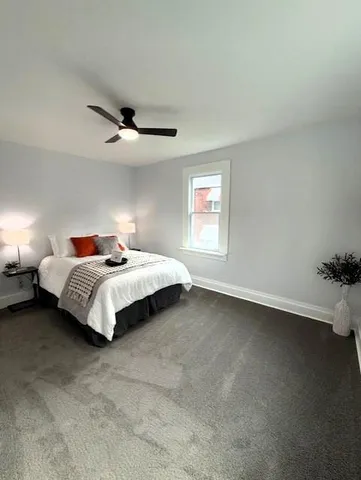 a bedroom with bed and window