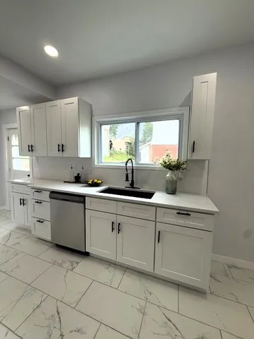 a kitchen with cabinets a sink and appliances