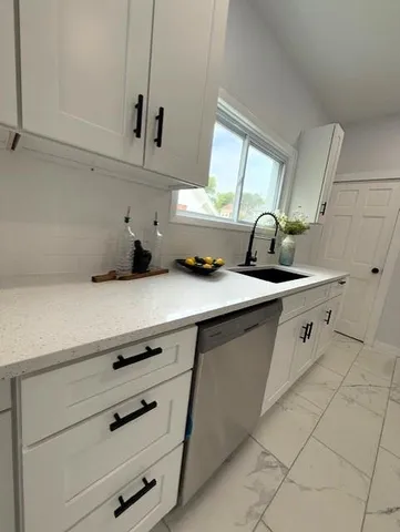 a kitchen with appliances cabinets and a window