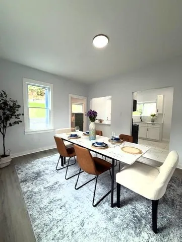 a view of a dining room with a table and chairs