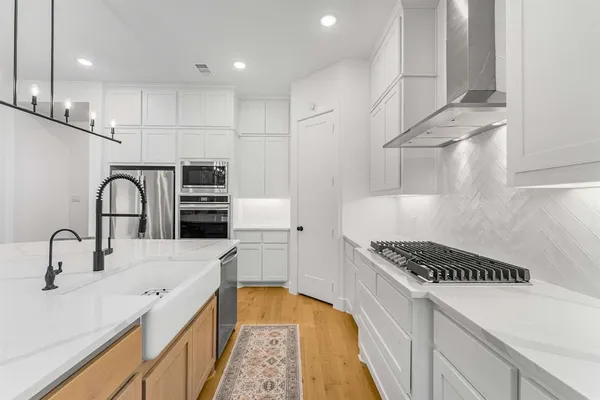 a kitchen that has a sink and a stove
