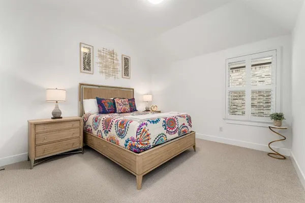 a bed sitting in a bedroom next to a window with yard