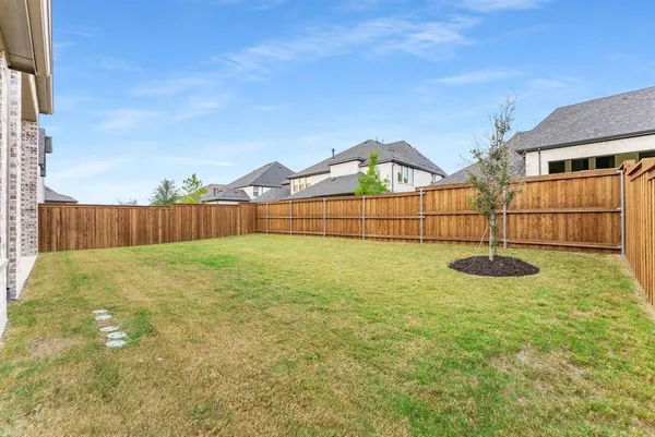 a view of backyard with trampoline