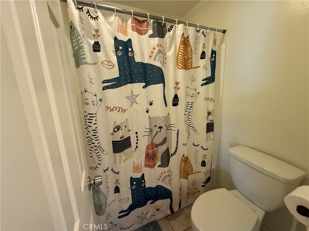 229 Springview Irvine, CA 92620 - Photo 12 of 16 a bathroom with a toilet and a shower curtain