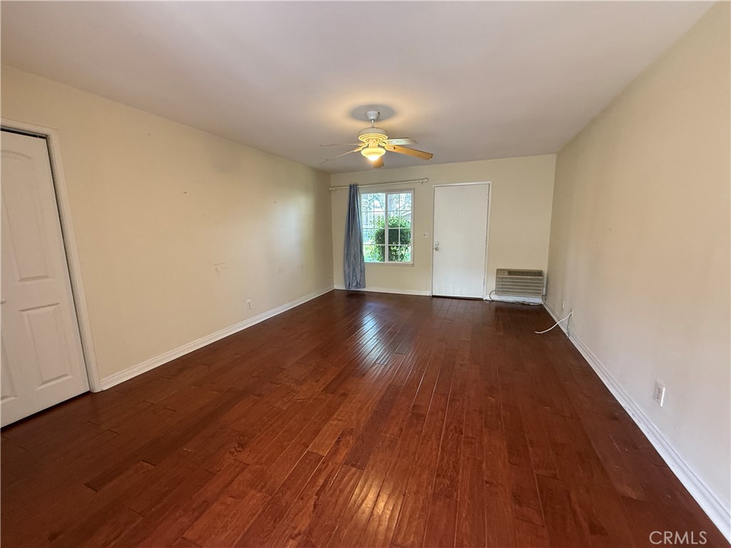 229 Springview Irvine, CA 92620 - Photo 3 of 16 an empty room with wooden floor and windows