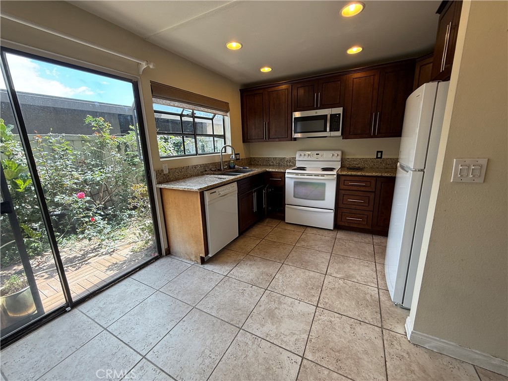 229 Springview Irvine, CA 92620 - Photo 6 of 16 a kitchen with stainless steel appliances granite countertop a refrigerator sink and stove