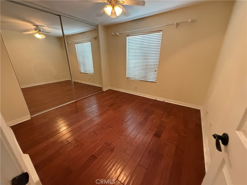 229 Springview Irvine, CA 92620 - Photo 9 of 16 a view of an empty room with window and wooden floor