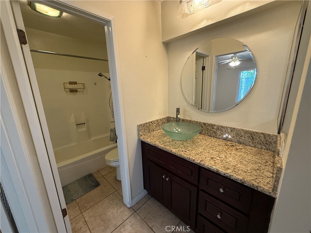 229 Springview Irvine, CA 92620 - Photo 10 of 16 a bathroom with a granite countertop sink toilet and shower