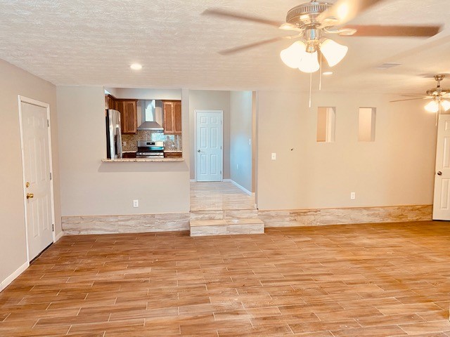 1602 Henninger Street Houston, TX 77023 - Photo 4 of 20 a view of a livingroom with wooden floor and a ceiling fan