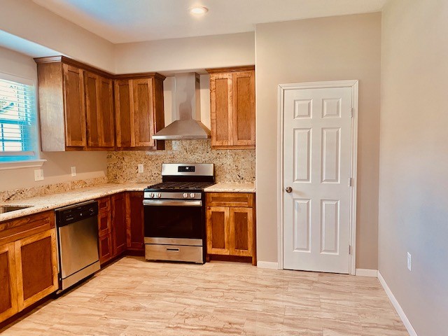 1602 Henninger Street Houston, TX 77023 - Photo 5 of 20 a kitchen with stainless steel appliances granite countertop a stove a sink and a refrigerator with wooden cabinets