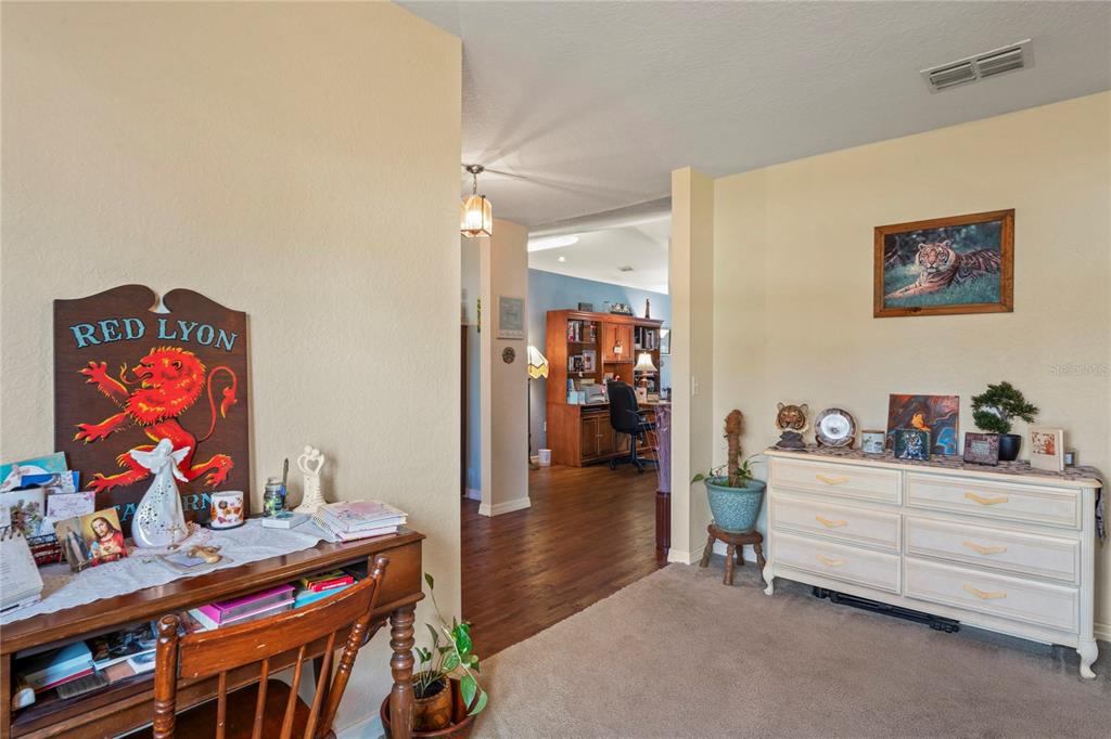 9086 Manchester Street Spring Hill, FL 34606 - Photo 11 of 50 a bedroom with furniture and a bed