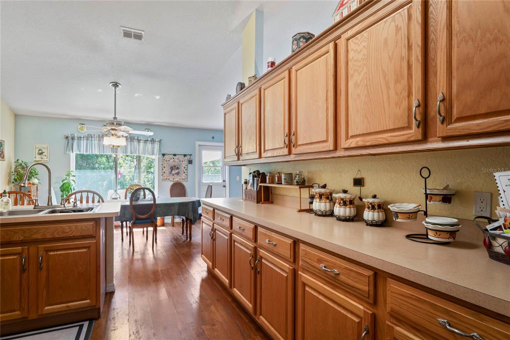 9086 Manchester Street Spring Hill, FL 34606 - Photo 12 of 50 a kitchen with sink cabinets and wooden floor