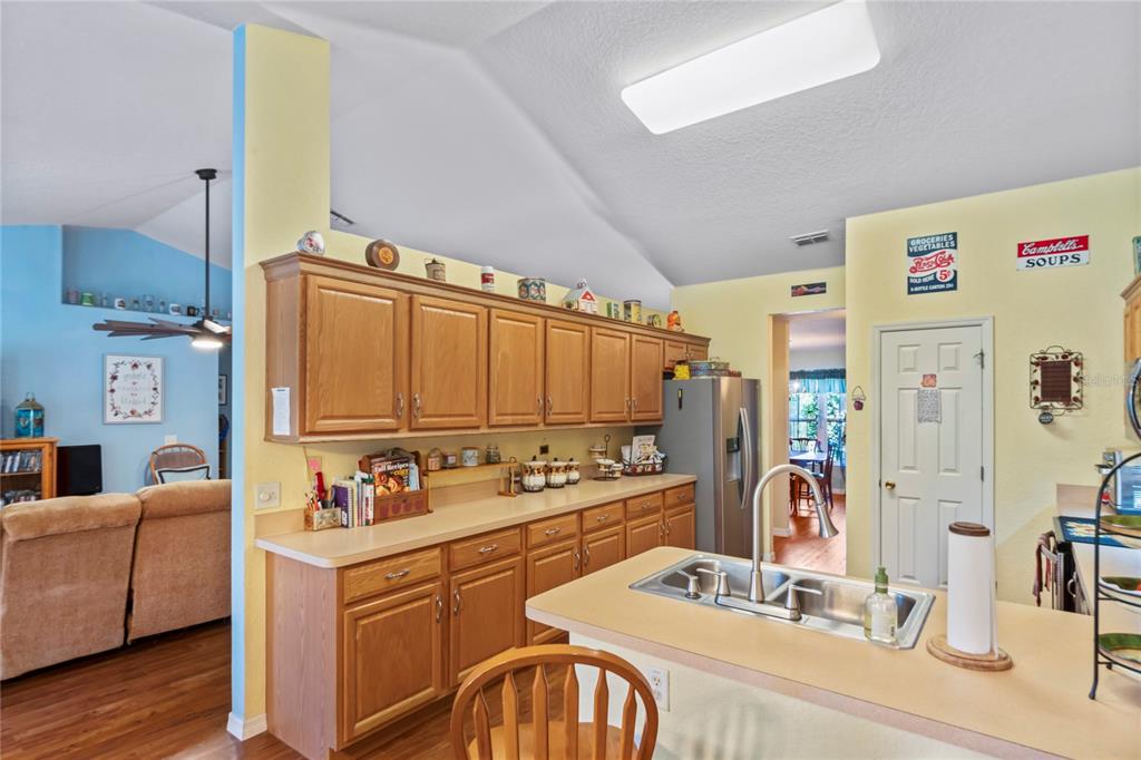 9086 Manchester Street Spring Hill, FL 34606 - Photo 16 of 50 a kitchen with a refrigerator and a stove top oven