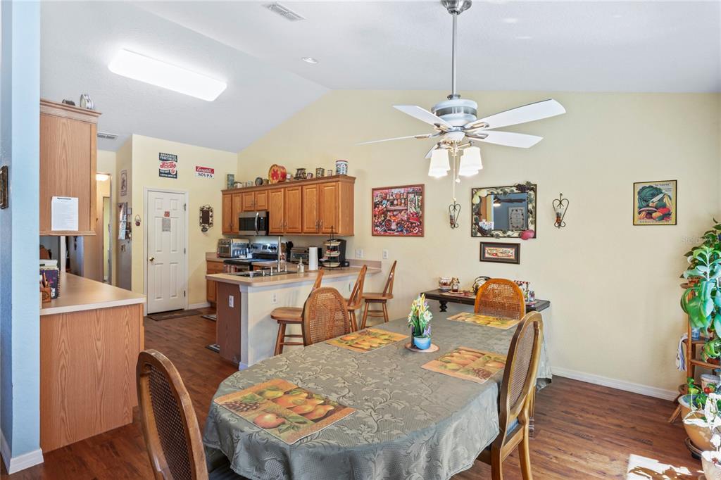 9086 Manchester Street Spring Hill, FL 34606 - Photo 18 of 50 a view of a dining room with furniture window and wooden floor