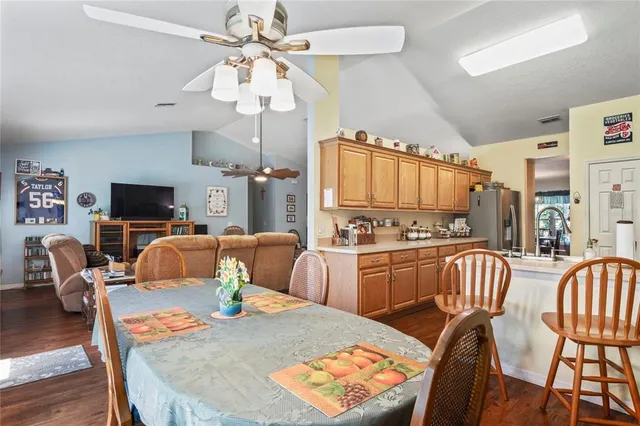 a view of a dining room with furniture wooden floor and chandelier