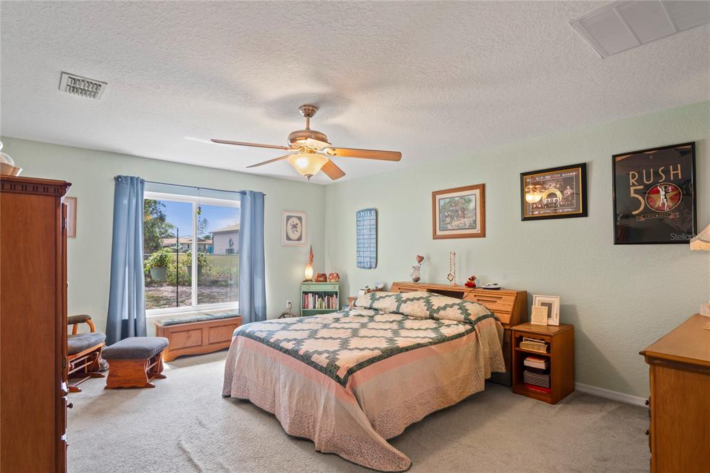 9086 Manchester Street Spring Hill, FL 34606 - Photo 23 of 50 a bedroom with bed and window
