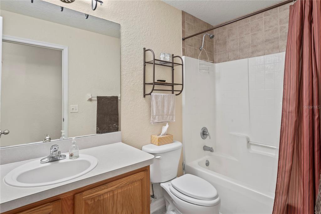 9086 Manchester Street Spring Hill, FL 34606 - Photo 30 of 50 a bathroom with a sink a toilet and shower