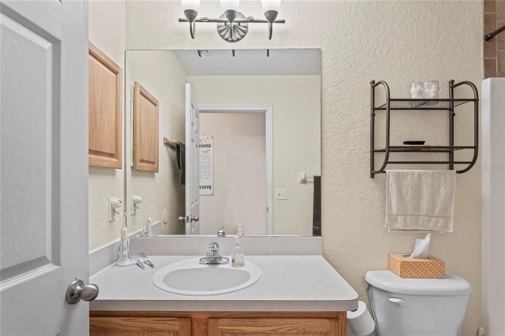 9086 Manchester Street Spring Hill, FL 34606 - Photo 31 of 50 a bathroom with a sink and a mirror
