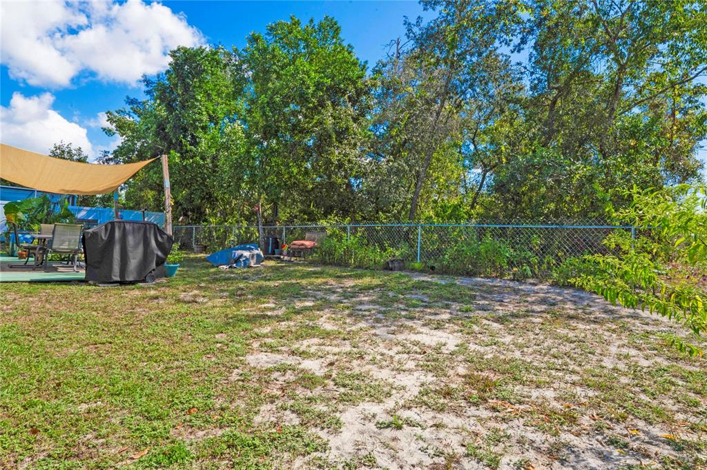 9086 Manchester Street Spring Hill, FL 34606 - Photo 38 of 50 a view of a yard with a trampoline