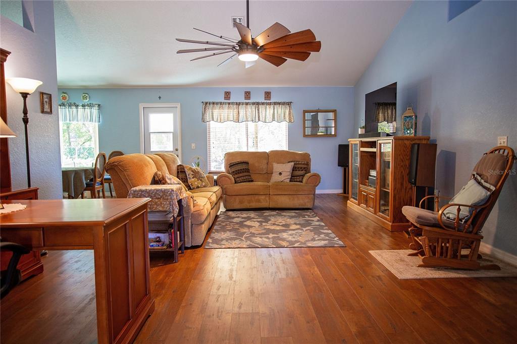 9086 Manchester Street Spring Hill, FL 34606 - Photo 4 of 50 a living room with furniture and a wooden floor