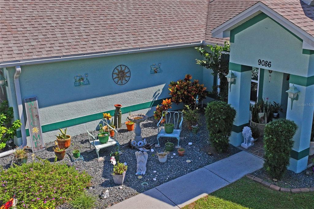 9086 Manchester Street Spring Hill, FL 34606 - Photo 44 of 50 a view of a chairs and table in a backyard
