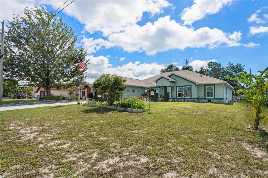 9086 Manchester Street Spring Hill, FL 34606 - Photo 46 of 50 a front view of house with yard and trees