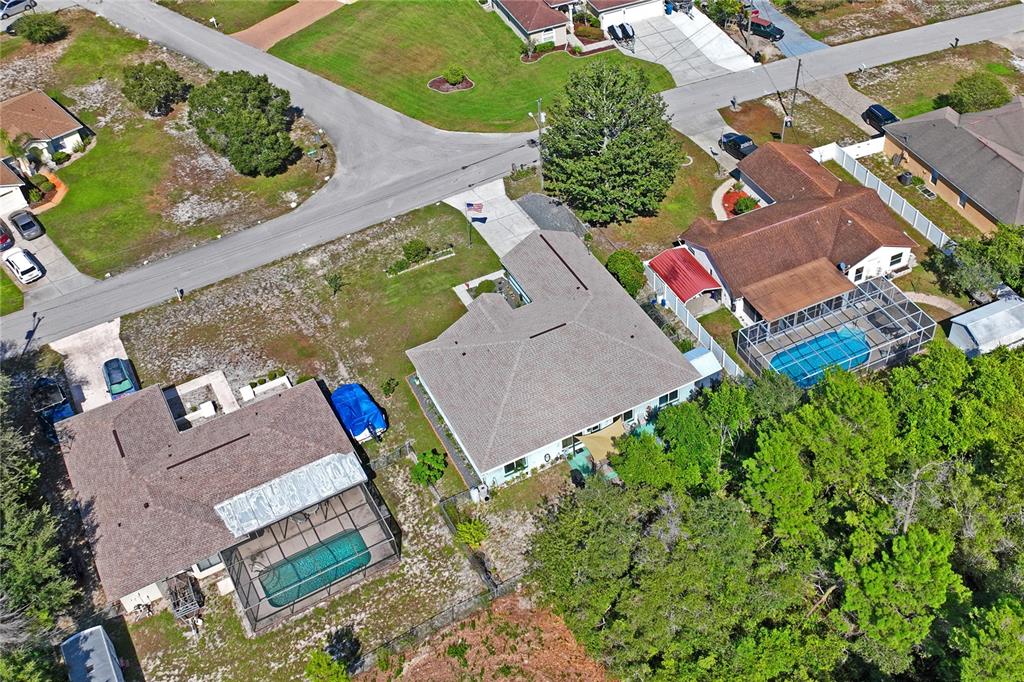 9086 Manchester Street Spring Hill, FL 34606 - Photo 49 of 50 an aerial view of a house with a yard and greenery